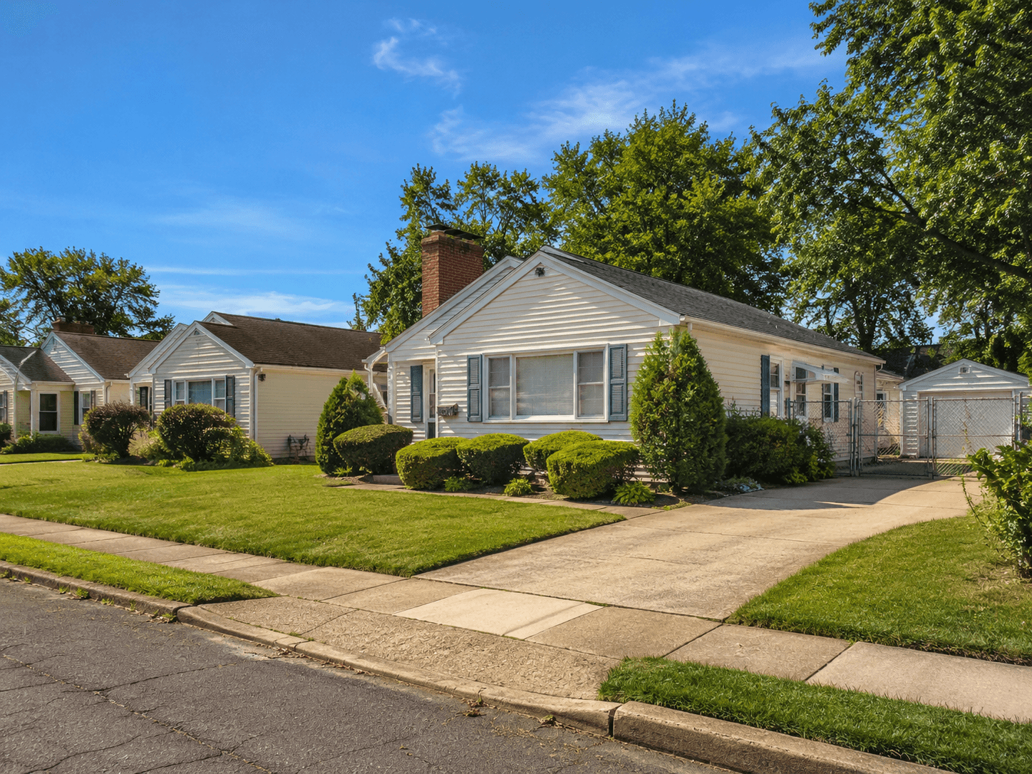 A sunny corner lot on a street of tidy ranch homes